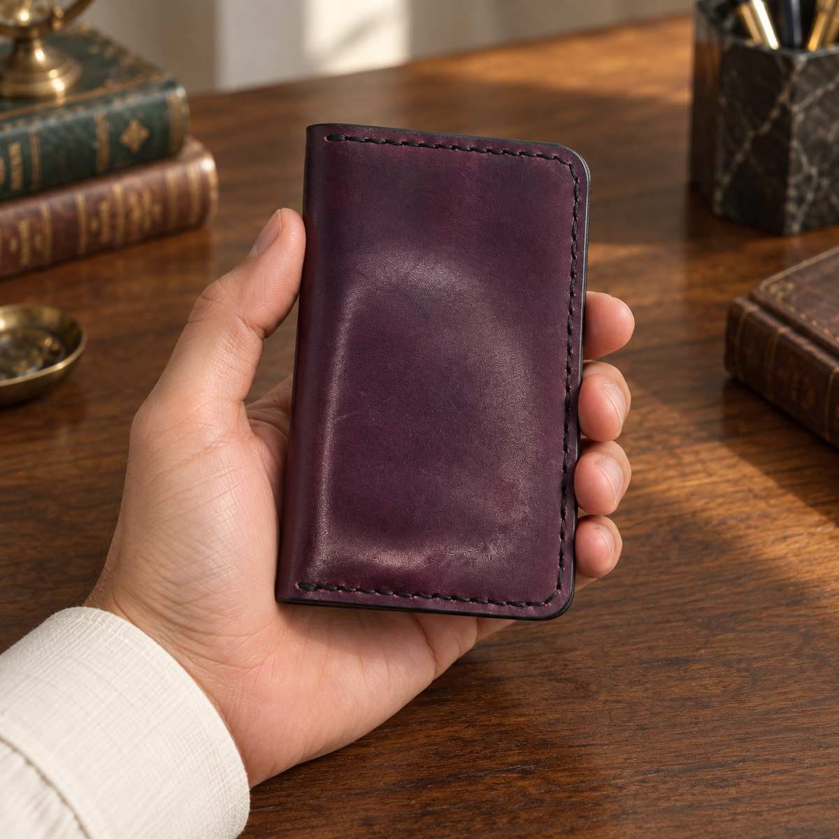 Aubergine Folded Card Holder, lifestyle shot, held in hand