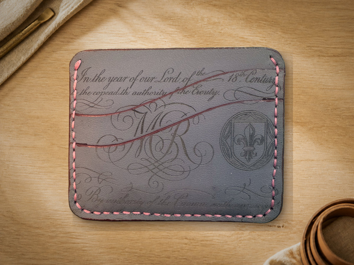 Petrol Blue Calligraphy Slim Card Holder, Large, front showing calligraphy engraving and fleur-de-lis crest